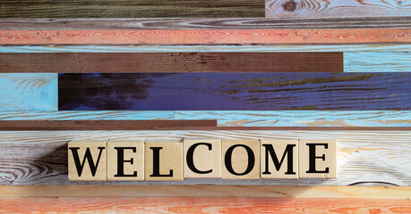 Word welcome written on wooden cubes. Holidays and education concept.