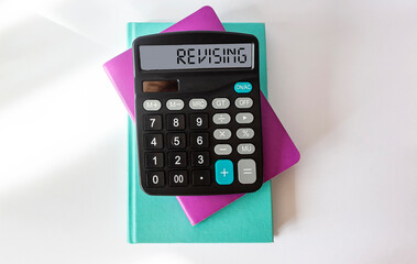 Revising, text on the calculator. Multi Colored notepads on white background