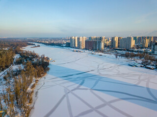 The frozen Dnieper river in Kiev. Aerial drone view. Winter sunny frosty morning.