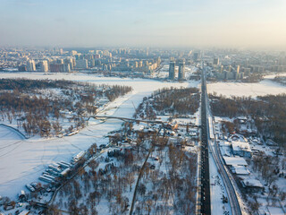 The snow-covered left bank of Kiev. Aerial drone view. Winter sunny frosty morning.