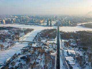 The snow-covered left bank of Kiev. Aerial drone view. Winter sunny frosty morning.