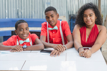 Latino brothers laughing at the camera with red shirt and white suspenders of Latino origin and dark skin