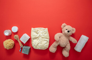 Baby bathing and diaper changing products background, top view