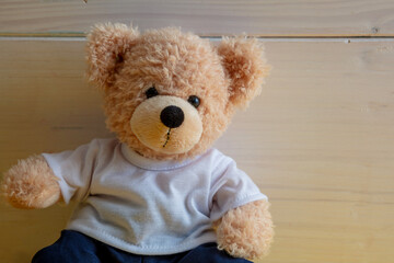 Teddy bear on white wood wall background, Kid alone concept