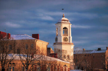 Fototapeta premium clock tower in the ancient city of Vyborg, Russia, in winter at sunset