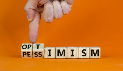 Pessimism or optimism symbol. Businessman turns cubes and changes the word 'pessimism' to...