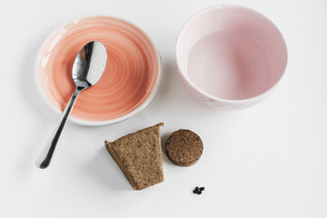 pot and tablet with earth and soil. saucer, spoon and container of water, Gardening at home. Growing food on windowsill. step by step spring planting plant seeds in a pot step three