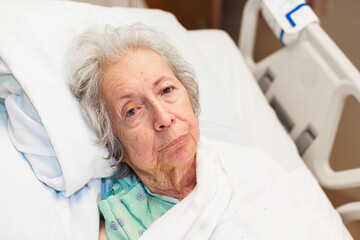 Elderly eighty plus year old woman in a hospital bed - 413331553