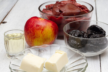 A set of products for making chicken liver pate with prunes and apple.