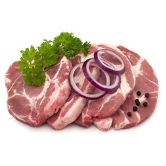 Raw pork neck chop meat with parsley herb leaves, peppercorn spices and onion slices garnish isolated on white background cutout