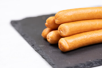 Cooked Hot Dogs served on the plate with white background