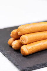 Cooked Hot Dogs served on the plate with white background