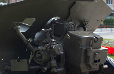Artillery, gun mechanism controls, green artillery cannon close - up in the park, anti-tank guns during World War II,