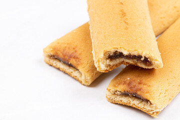 Cookies with fruit filling above white background