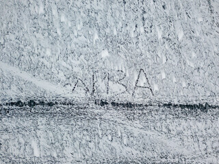 The inscription "Lisa" on the ice. Aerial drone view. Frosty winter morning.