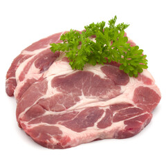 Raw pork neck chop meat with parsley herb leaves garnish isolated on white background cutout