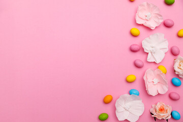 Easter bunny. Happy Easter holiday background concept.Flat lay colorful bunny egg with accessory to celebration on modern rustic pink pastel paper at home office desk.