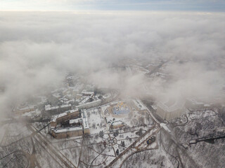 Obraz premium Fog over the snow-covered St. Michael's Cathedral in Kiev. Aerial drone view. Foggy winter day.