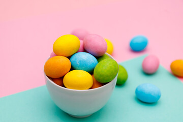 Easter bunny. Happy Easter holiday background concept.Flat lay colorful bunny egg with accessory to celebration on modern rustic pink pastel paper at home office desk.