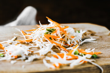 carrot and cabbage salad on wooden board