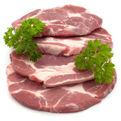 Raw pork neck chop meat with parsley herb leaves garnish isolated on white background cutout