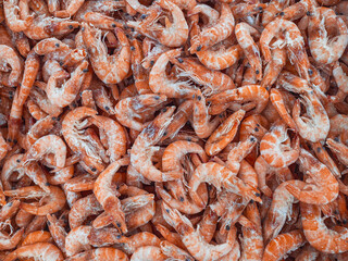 Background from a large number of frozen shrimp. Background from seafood on a shop window.