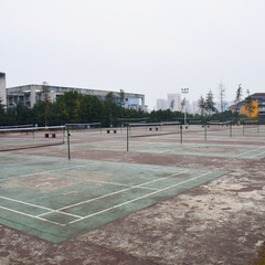Obraz premium Chongqing, China - December 24 2019: An eerie, run down scene of dozens of badminton courts at the Chongqing University under a continuous grey sky