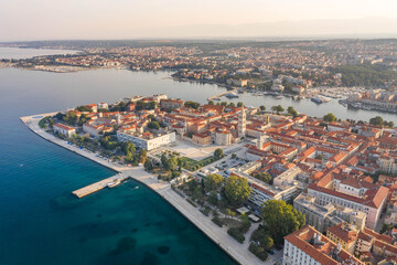 Aerial drone shot of Zadar old town peninsula with sea organ in sunrise in Croatia Dalmatia