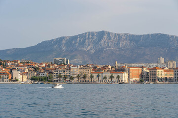 Speed boat towards Split old town riva with view of Mount Morso in early morning in Coratia
