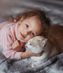 Beautiful little girl with her cat close up