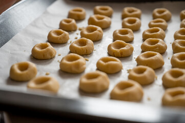 Detail of plate full of home made cookies ready to be baked.