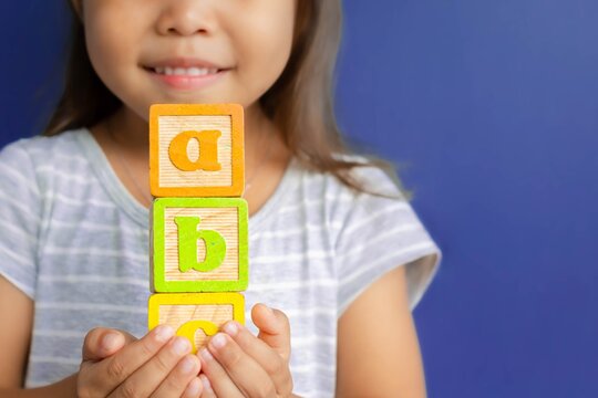 A Happy Little Kid Learning Abc With Blocks. Children Learning.