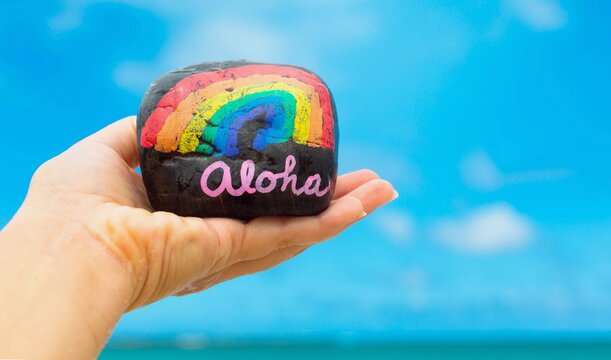 Hawaii vacation. Aloha with a rainbow on the beach.