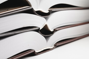 Binding of a new book. Close-up of a layer of pages. Library background