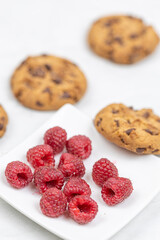 Crunchy biscuits with chocolate and fresh raw raspberries