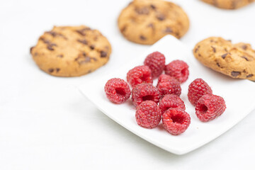 Crunchy biscuits with chocolate and fresh raw raspberries