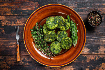 Fried vegetarian broccoli vegetable burgers patty on a rustic plate. Dark wooden background. Top view