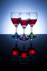 Wine glasses with three colored stems.