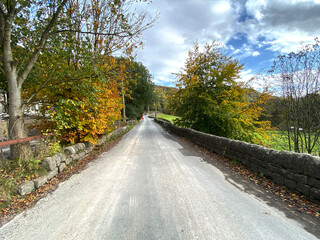 View along, Midgehole Road, in autumn, with dry stone walls near, Hebden Bridge, UK