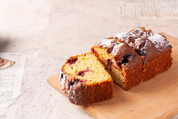 Wheat flour muffin with cherries on a blackberry table.Close up.
