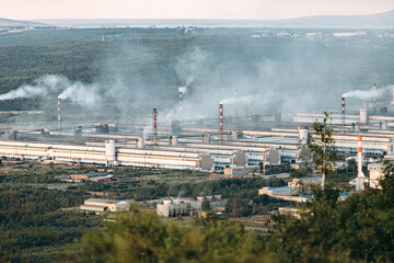 Aerial view of the factory. Environmental pollution. The pipes emit smoke into the atmosphere.