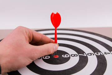 red dart darts in the center of the target hit the target won