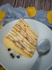 A slice of the medovik or Russian honey cake, a famous cake originated from Soviet Union. Selective focus points. Blurred background