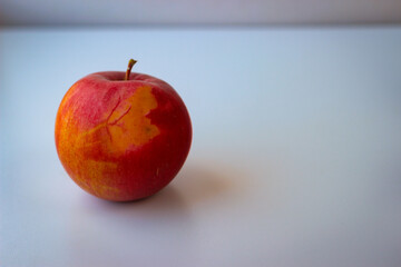 Red apple stand on a white surface