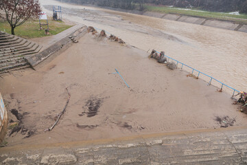 River after flood with plastic and wood pollution . Vlasina river, Serbia. Ecology problem.