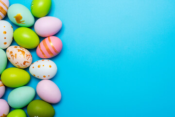 Fototapeta na wymiar Easter Eggs. Colorful Easter eggs on blue background with copy space. Easter background