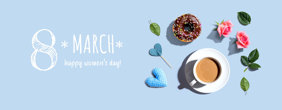 Happy womens day message with a cup of coffee and a donut - flat lay