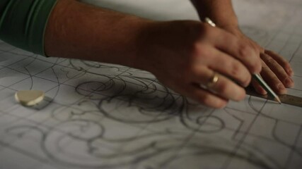 Man hands preparing pattern in carpentry workshop. Guy drawing design in studio