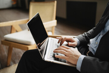 a lawyer in a business suit works on a laptop computer. prints the message 5G communication. an economist in a business suit is sitting in the office.