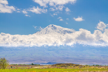 Naklejka premium Mount Ararat (Turkey) at 5,137 m viewed from Yerevan, Armenia. This snow-capped dormant compound volcano consists of two major volcanic cones described in the Bible as the resting place of Noah's Ark.